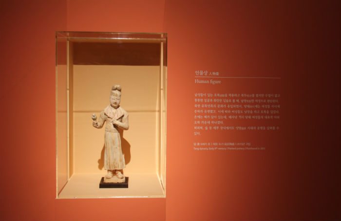 This human-like figurine is believed to have been manufactured in the early 8th century in China during the Tang Dynasty. The figurine is believed to be female, though she is wearing a man's garments and headgear. Archeologists believe it represents a woman taking part in a traditionally 