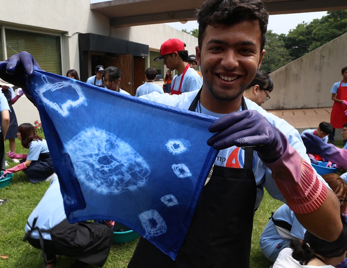 Summer camp participants take part in making naturally dyed handkerchiefs while on Jeju Island.