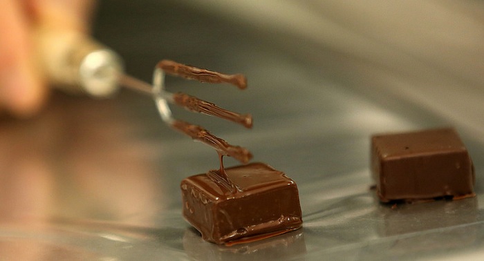 Chocolatier Hong Gyoung-chun shows how to do a 'dipping' of the chocolate, one of the main chocolate-producing processes.