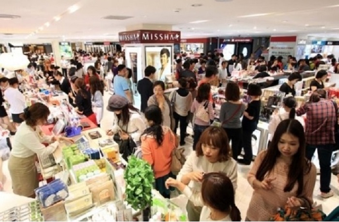 The streets and stores of Myeongdong are packed with tourists and shoppers.