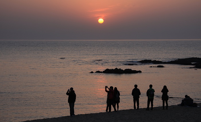 Tourists gather at the <i>Jeongdongjin</i> early in the morning to view the sunrise.
