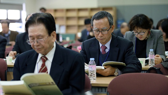 Conference participants concentrate on the research results.