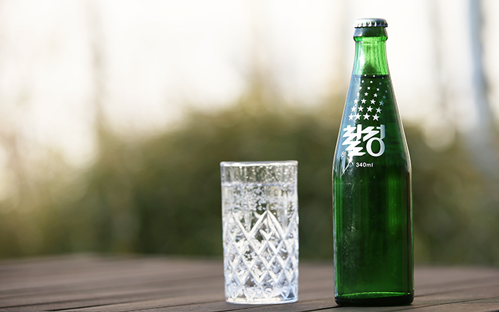 The green transparent glass bottle, white stars and white lettering are the signature marks of Chilsung Cider.