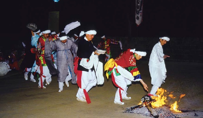 Dancers burn their masks after a performance. 