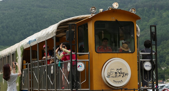 Tourists take photos at around Scenery Train railroad. 