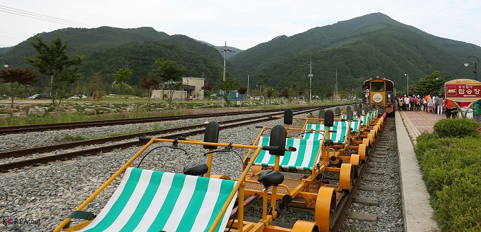 Tourists wait to ride a pedal bike handcar, one of the highlights of Jeongseon.