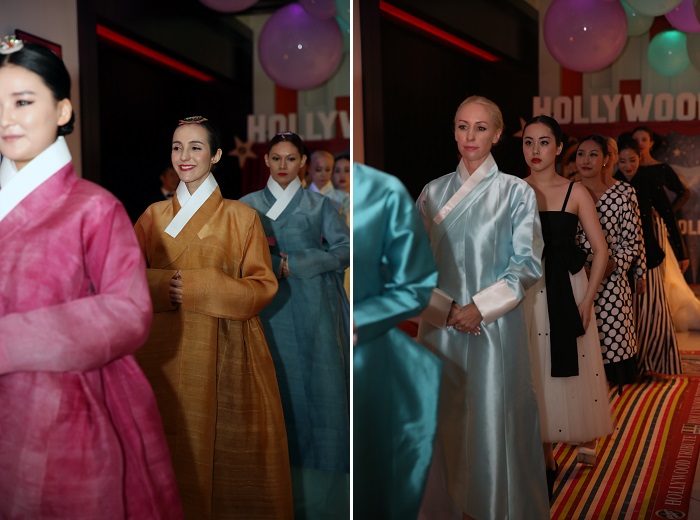 Models walk the catwalk in various Hanbok outfits, bringing different colors and designs to the stage. 