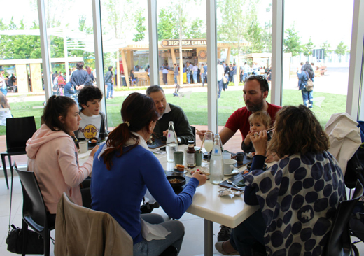 A group of visitors eat Korean food served at the national pavilion.