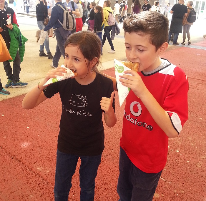Young expo-goers try out the goldfish waffles at the Korean Pavilion.