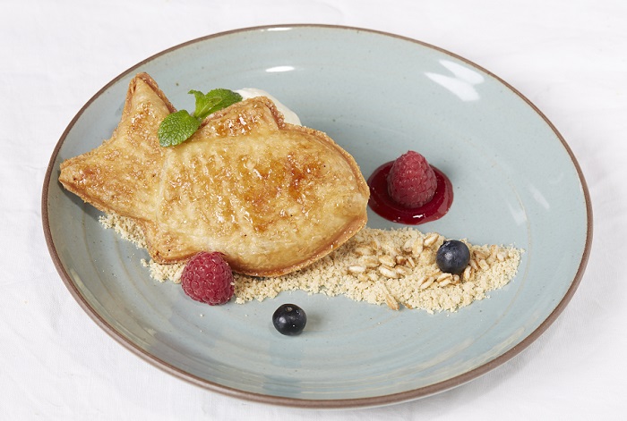 A goldfish waffle with berries.