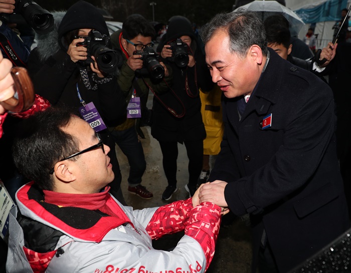 ‘Kim Mun Chol, North Korea’s chief representative at the PyeongChang 2018 Paralympic Winter Games, shakes hands with Lim Chan-gyu, director of the PyeongChang Paralympics Committee, as Kim leaves the Paralympic Village in Gangwon-do Province. 