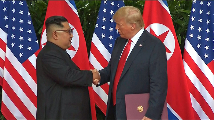 North Korea’s Chairman of the State Affairs Commission Kim Jong Un (left) and U.S. President Donald Trump shake hands after signing a joint agreement at the Capella Hotel in Singapore where they held a summit on June 12. (Yonhap News)