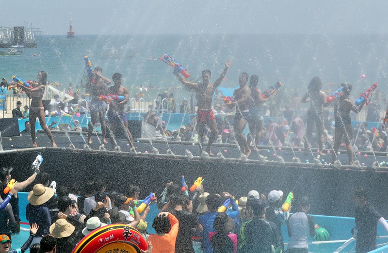 Participants at the Busan Sea Festival in 2018 use water guns in the event
