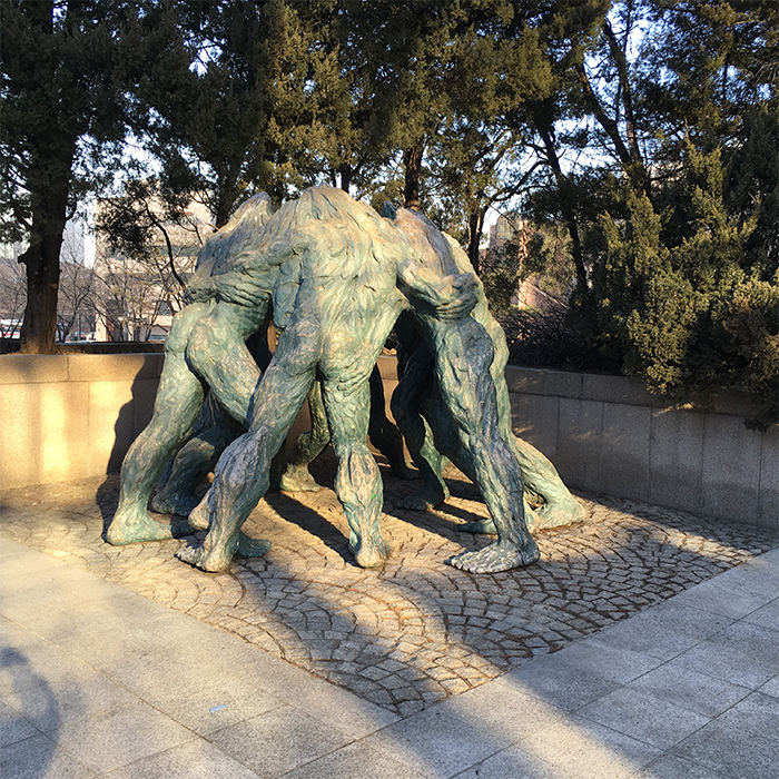 The Youth Academy building has a sculpture showing several people coming together as one.