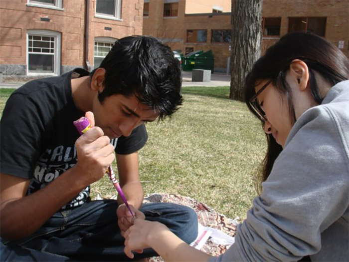 My friends decorate their hands with Pakistani henna