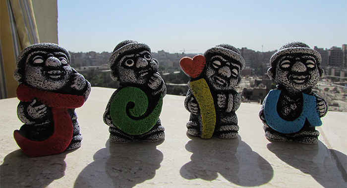 Cute <i>Dol hareubangs</i> souvenirs holding each letter of the Island.