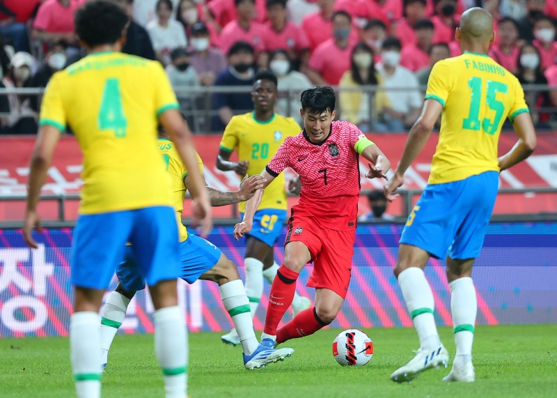Striker Son Heung-min on June 2 dribbles the ball surrounded by Brazilian players in a friendly game at Seoul World Cup Stadium in the city's Mapo-gu District.