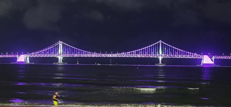 The Gwangandaegyo Bridge in Busan is covered in purple lights ahead of the Oct. 15 BTS concert to promote the city's bid to host the 2030 World Expo. (Busan Metropolitan City) 
