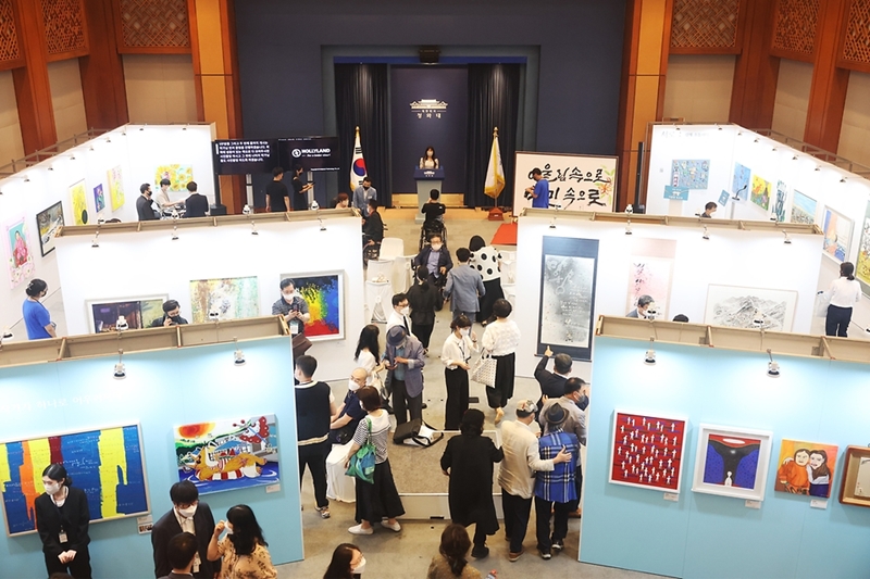 Visitors in August 2022 look around at an exhibition of the works of disabled artists dubbed 