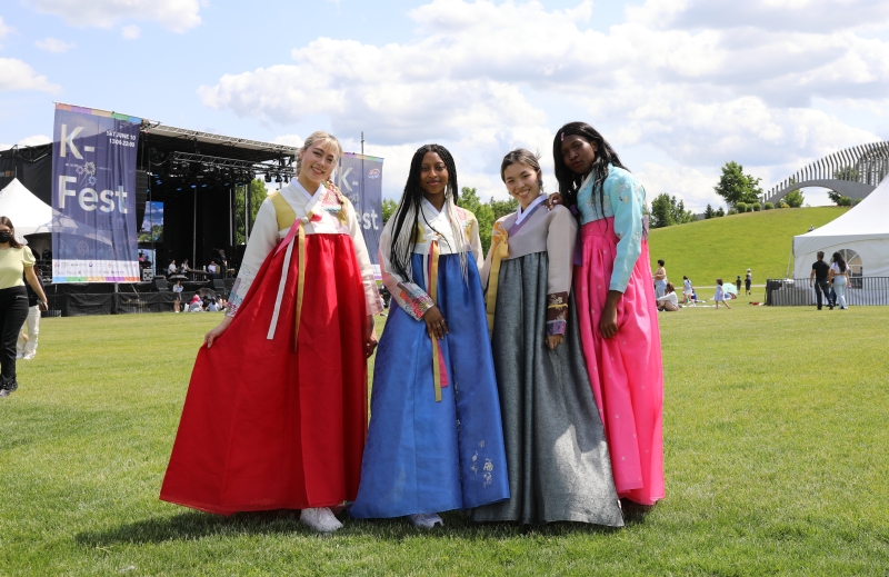 Visitors to K-Fest clad in Hanbok (traditional clothing) on June 10 pose for photos at Lansdowne Park in Ottawa, Canada.