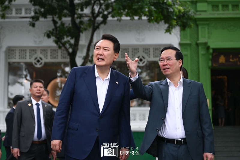 President Yoon Suk Yeol on June 24 listens to Vietnamese President Vo Van Thuong's explanation while walking around Hoan Kiem Lake in Hanoi. 