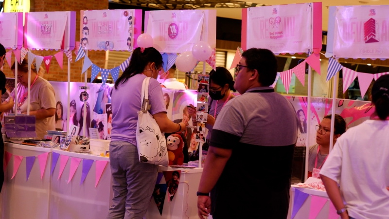 Visitors on July 1 explore fan club booths of K-pop groups near the venue of the festival 