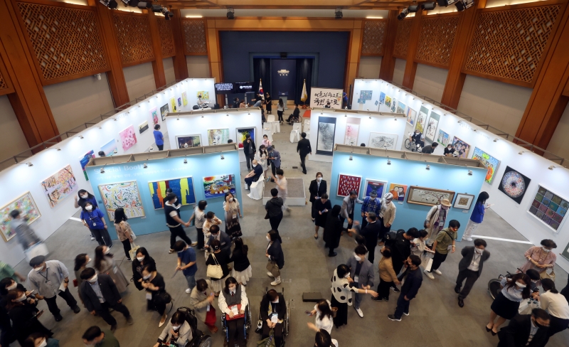 Visitors last year view artworks at an exhibition for disabled=
