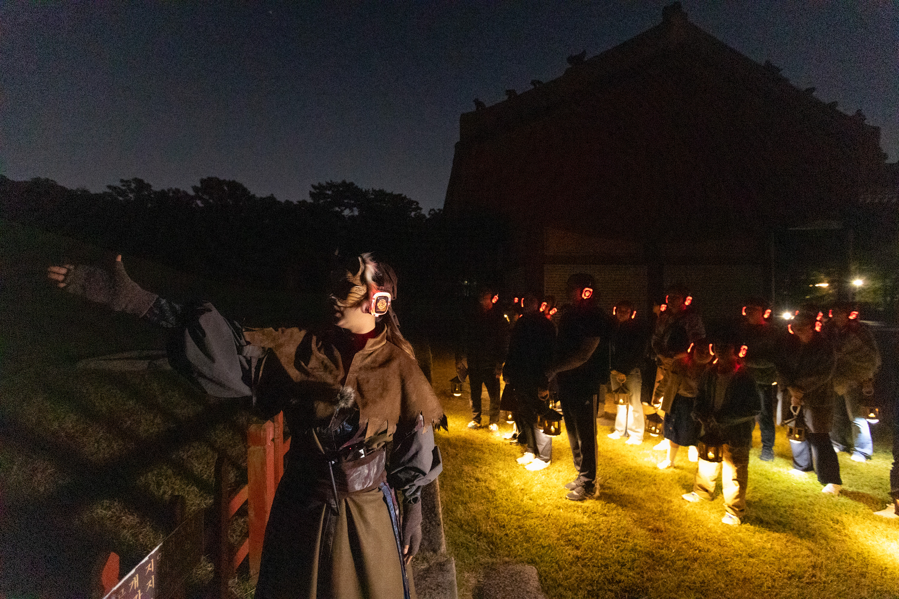 A guide dressed as the feline character Myomyo on Oct. 16 gives an explanation on Myeongneung, the twin tombs of Joseon Dynasty King Sukjong and his second wife, Queen Inhyeon, on the Seooreung Night Tour at the Royal Tombs of the Joseon Dynasty in Goyang, Gyeonggi-do Province. 
