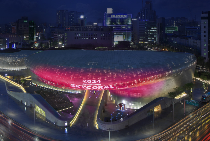 Sky coral, the official 2024 color of the city of Seoul, illuminates Dongdaemun Design Plaza in Seoul's Jung-gu District.