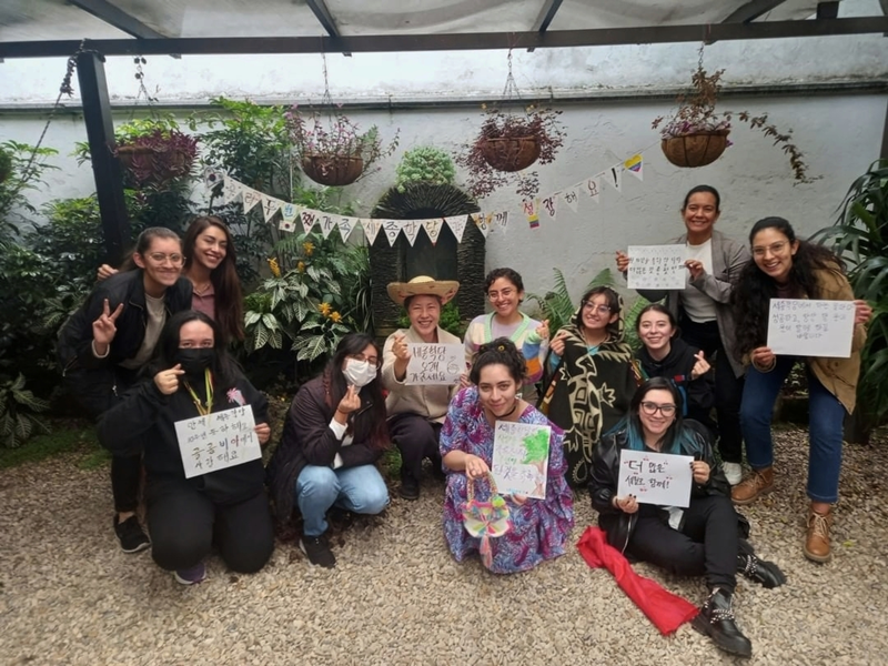 Students at King Sejong Institute in Bogota, Colombia, in September 2022 take a group photo to mark the 10th anniversary of the branch while holding papers on which they wrote their wishes in calligraphic Hangeul. 