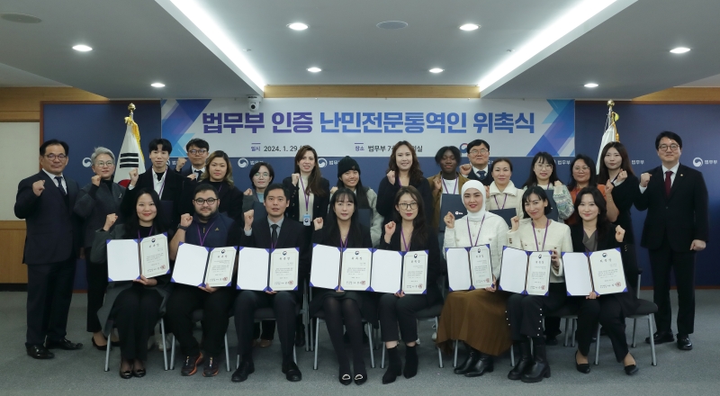 Acting Minister of Justice Shim Woo Jung (right) on Jan. 29 poses for a group photo with newly appointed interpreters for the refugee screening process at their appointment ceremony held at Government Complex-Gwacheon in Gwacheon, Gyeonggi-do Province. (Ministry of Justice) 
