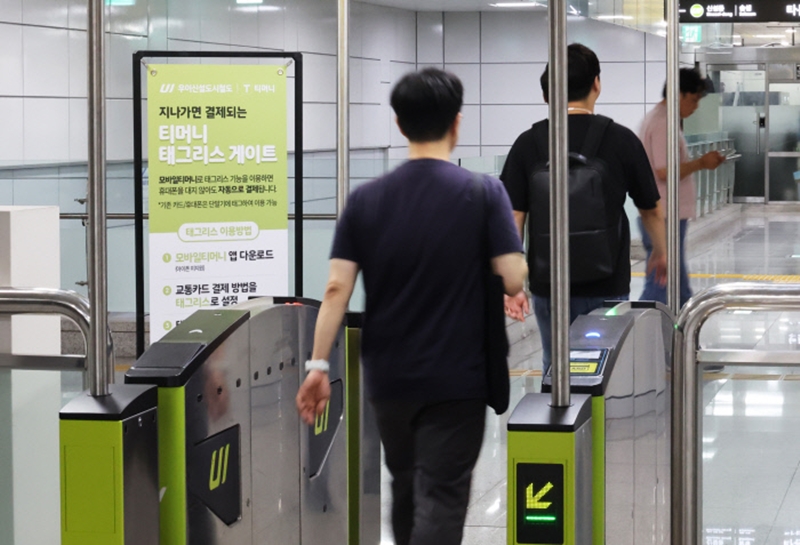 A commuter goes through a fare gate without swiping his transportation card under the 