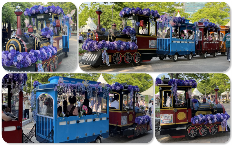 A flower train decorated with blossoms of violet and indigo hues circle the lake park.