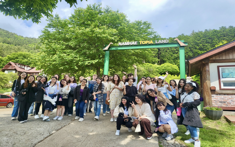 Honorary Reporters and K-influencers pose in front of Namhae Topia Land.