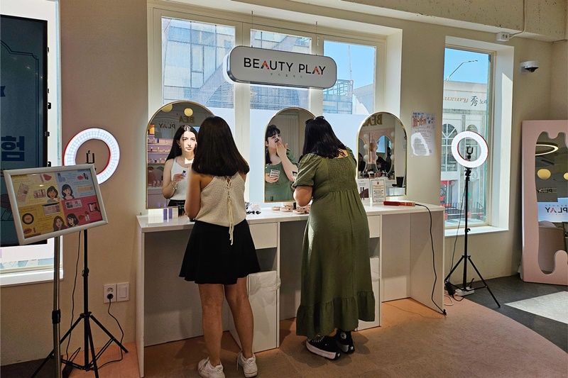 Turkish visitor Dylan Yaffes (right) finishes putting on makeup with a friend at the self-makeup zone on Beauty Play's third floor after getting her eyes done.
