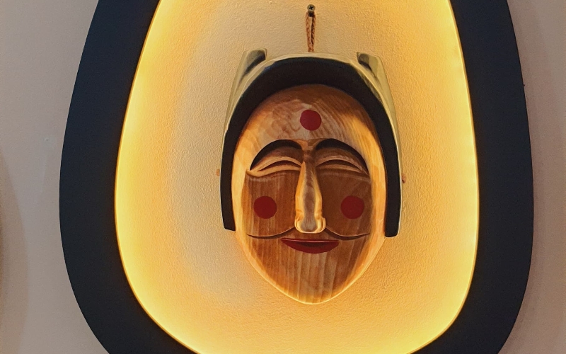 Mask of young married woman embodying conventional beauty with an oval face, high nose, and small mouth.