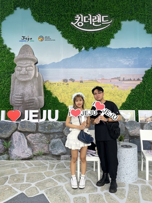Two visitors pose for pictures at the photo zone for the K-drama 