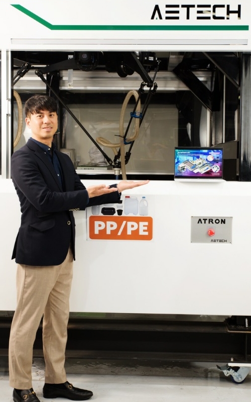 Aetech Chief Strategy Officer Ryu Jae Ho poses with Atron, his company's AI-based optical sorting robot. 