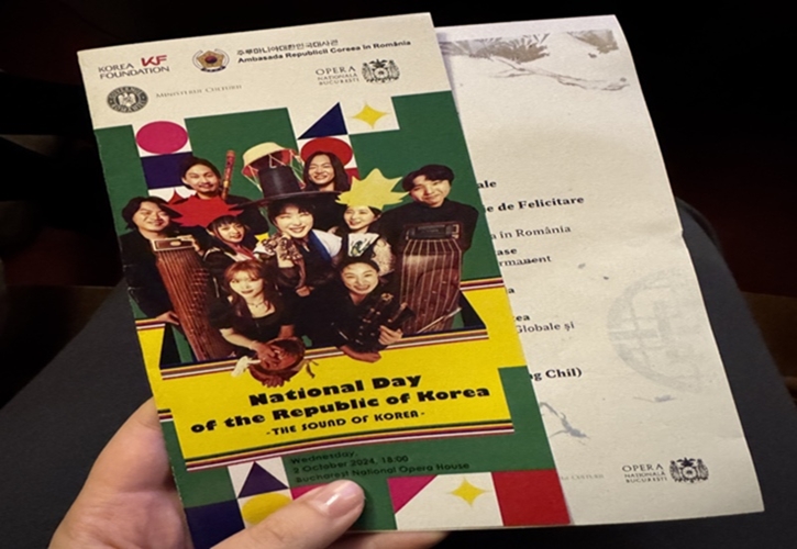 This photo shows me holding the brochure of the National Day of the Republic of Korea.