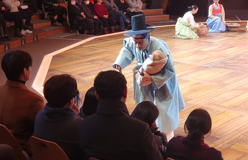 The live theater genre madangnori features the interaction of the audience and cast. Shown is the character Sim Bongsa (the Blind) on Nov. 28 looking for breastmilk to feed his infant daughter at the premiere of 