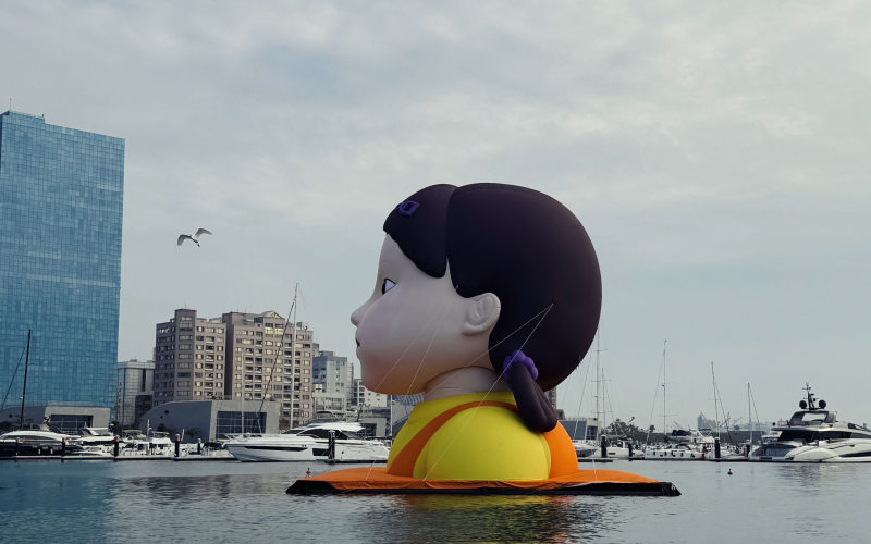 Side view of inflatable Young-hee floating on the Love River, taken while onboard the Love River cruise.