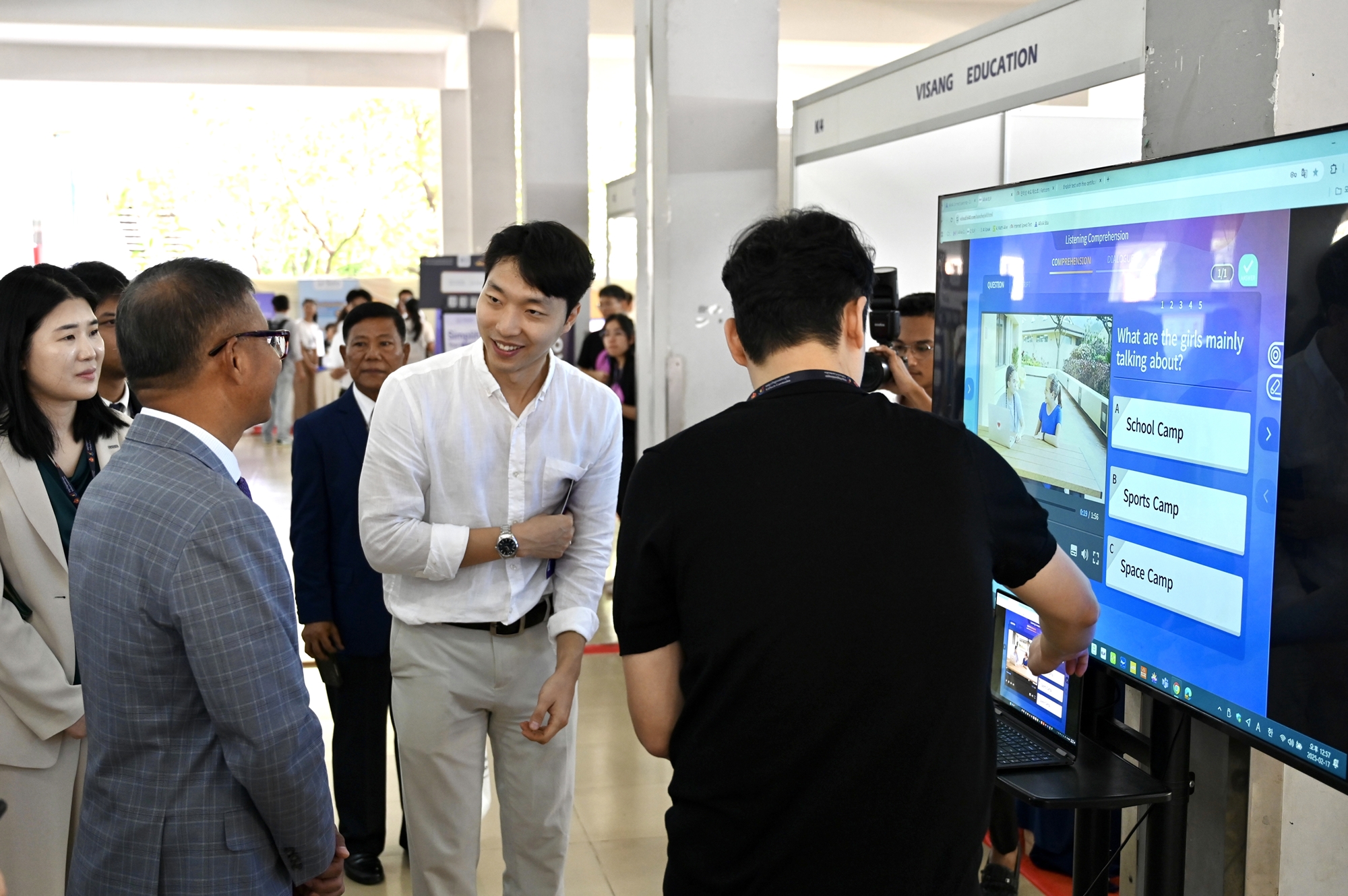 Cambodian Deputy Prime Minister and Minister of Education Youth and Sport Hang Chuon Naron (left) on April 17 gets firsthand experience in digital education content at the booth of Korean company Visang Education at the first Cambodia EdTech Summit held at the Institute of Technology of Cambodia in Phnom Penh. (Korea International Cooperation Agency)  