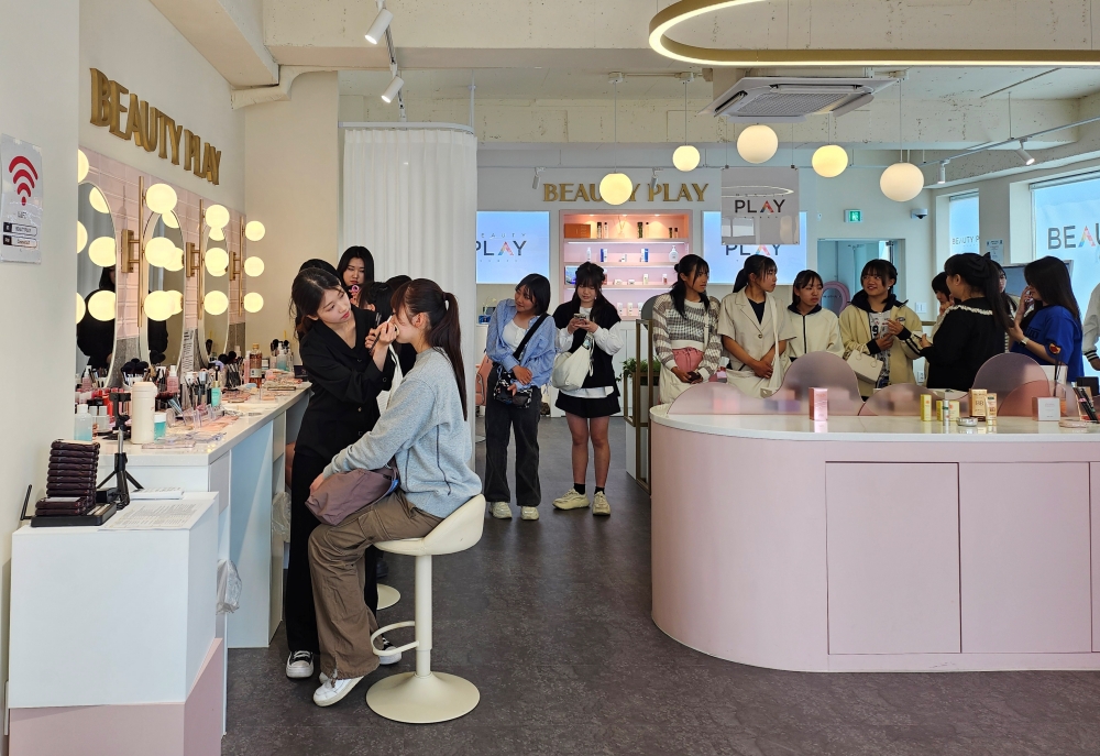 The Ministry of Culture, Sports and Tourism is hosting this year's Korea Beauty Festival from June 19 to July 18 jointly with the Visit Korea Committee and the Korea Tourism Organization. Shown are foreign tourists in May last year getting made up at Beauty Play Hongdae, a cosmetics exhibition and interactive center, in the popular Hongik University area of Seoul. (Korea.net DB) 