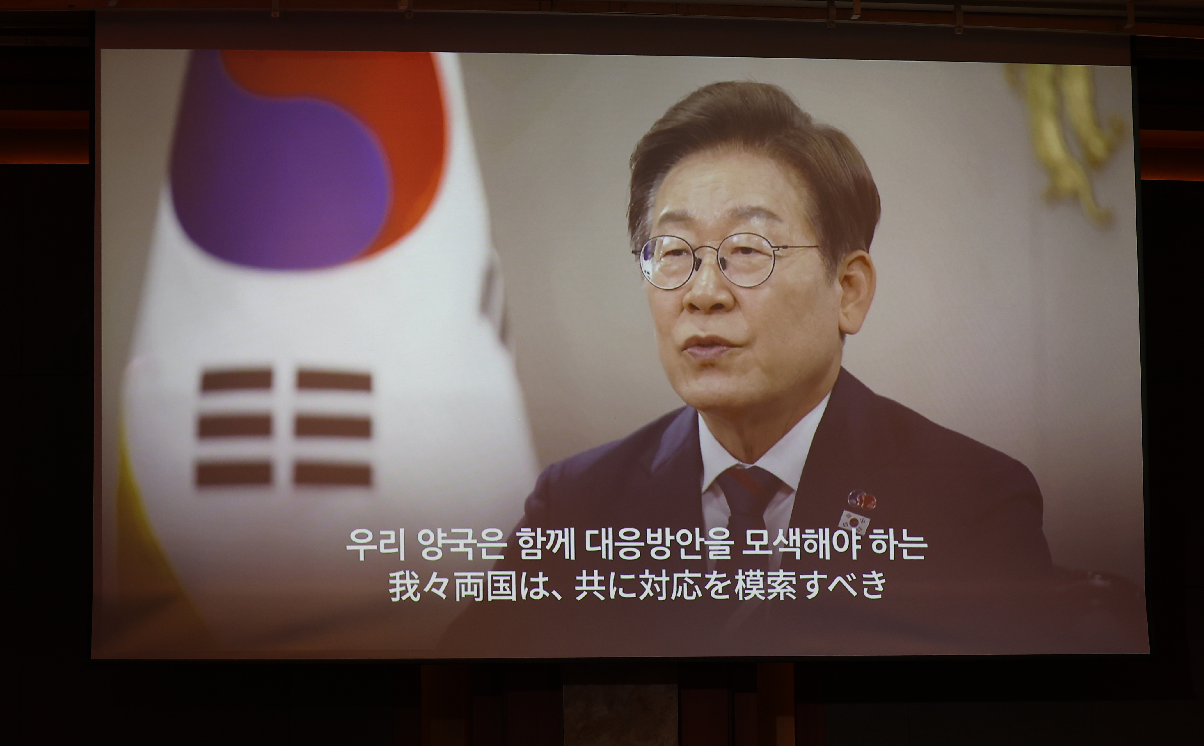 President Lee Jae-myung stresses stronger cooperation with Japan in a congratulatory video message shown at a reception on June 16 in Seoul marking the 60th anniversary of Korea's normalization of ties with Japan. (Yonhap News)