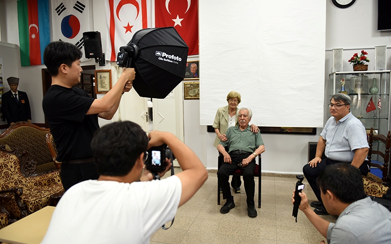 Photographer Shin Jung-hwan taking a photo of a Korean War veteran with his wife. (Ece Yildirim)