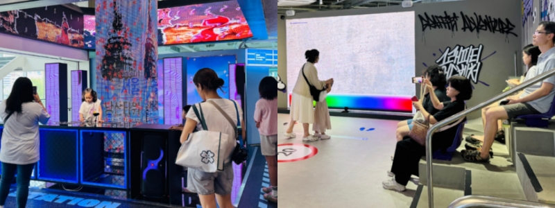  Korean families enjoying the interactive DJ station (left) and digital graffiti (right) at HiKR Ground’s Art Street. 