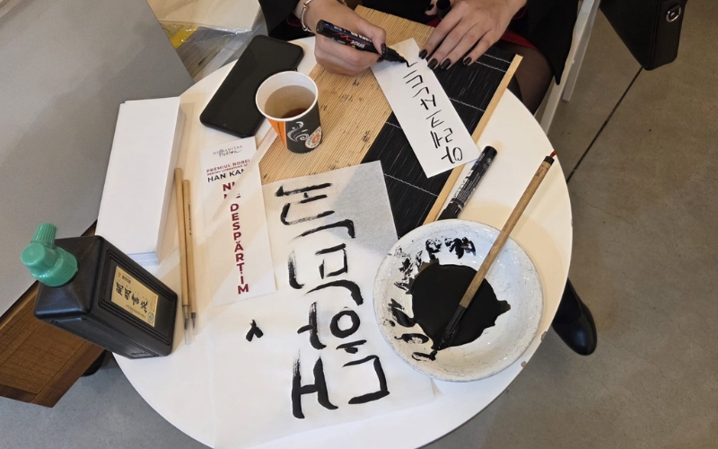 Korean calligraphy with brushes and ink held after the event.