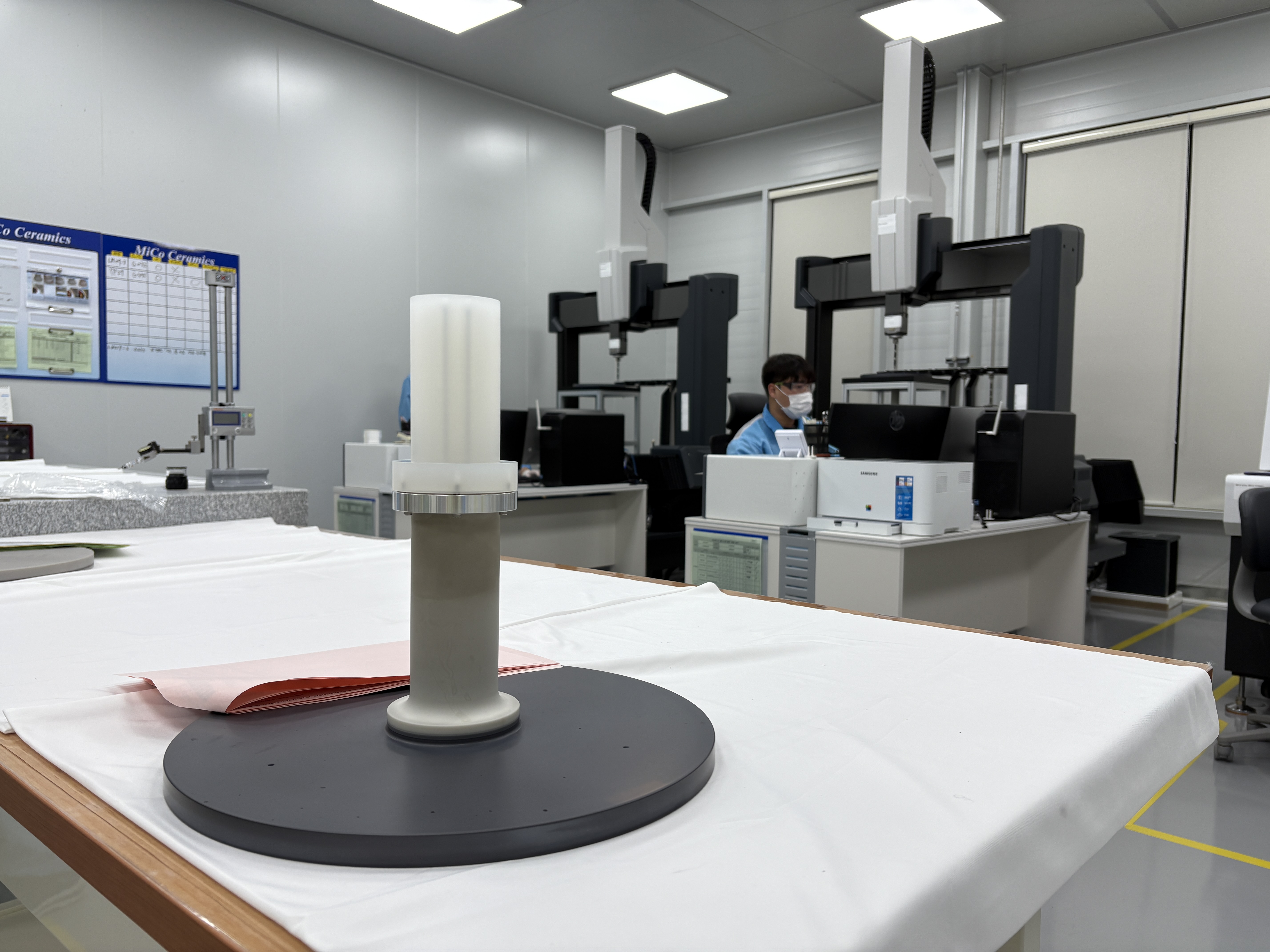 A staff member of MiCo Ceramics on Nov. 6 measures the size of the component of an aluminum nitride heater used in semiconductor equipment at the quality inspection room of the company's No. 4 plant in Gangneung, Gangwon-do Province. A precise dimensional check is crucial for verifying if the material meets design standards.  