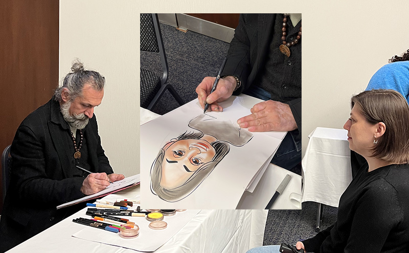 Caricature artist drawing visitors at the booth.