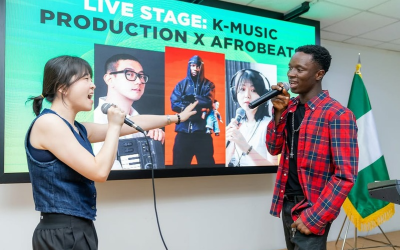 Vocalist Seo Yena performing live on stage, in collaboration with Nigerian artist FirstKlaz.